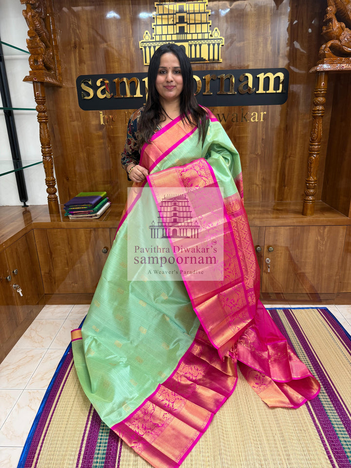 Pista Green with Rani Pink , rich Zari Podi Kattam in the body , one side short and long borders with rich Pallu Korvai Silk Cotton Saree
