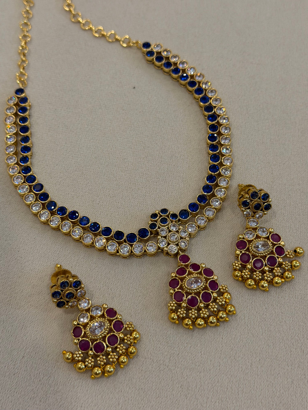 Two line elegant blue & white addigai necklaces, paired with a stunning red & white statement pendant and matching ear drops.