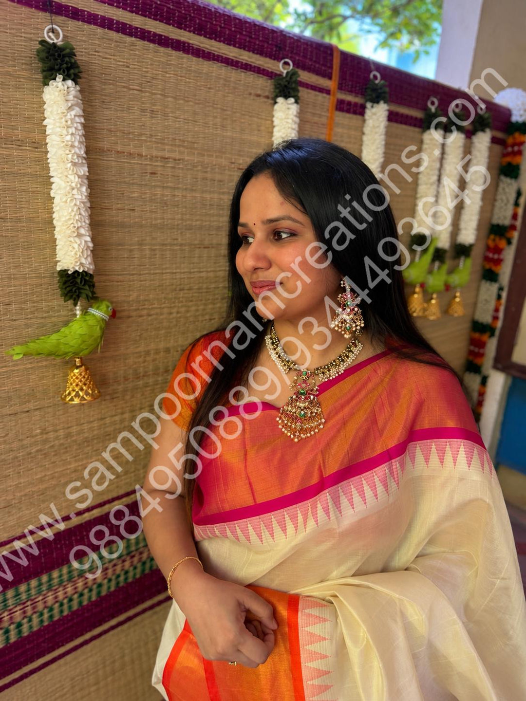An exquisite antique finish jadau choker, intricately detailed with red, green and white stones, cascading pearls,with a statement pendant and floral jhumka inspired earings.
