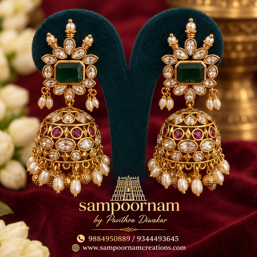A Stunning Kemp style Jhumka featuring a Rich Emerald - Green centre stone , surrounded by Sparkling White Stones and Delicate Pearl accents