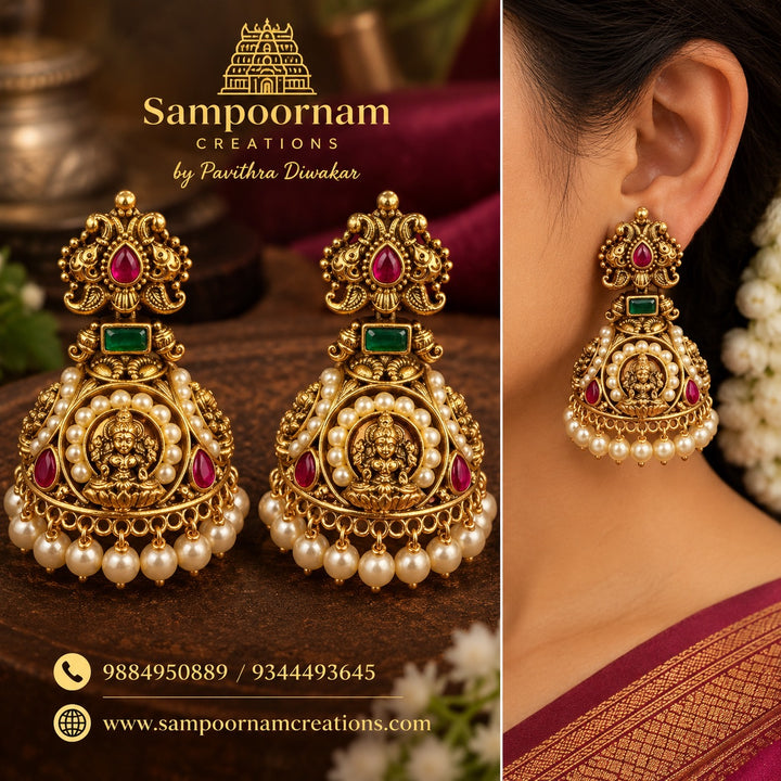 A Magnificent Lakshmi temple - Jewellery - inspired Jhumka featuring an intricate Goddess Lakshmi motif , Rich Ruby -Red and Emerald - Green stones and delicate Pearl detailing , Finished with Cascading Pearl hangings
