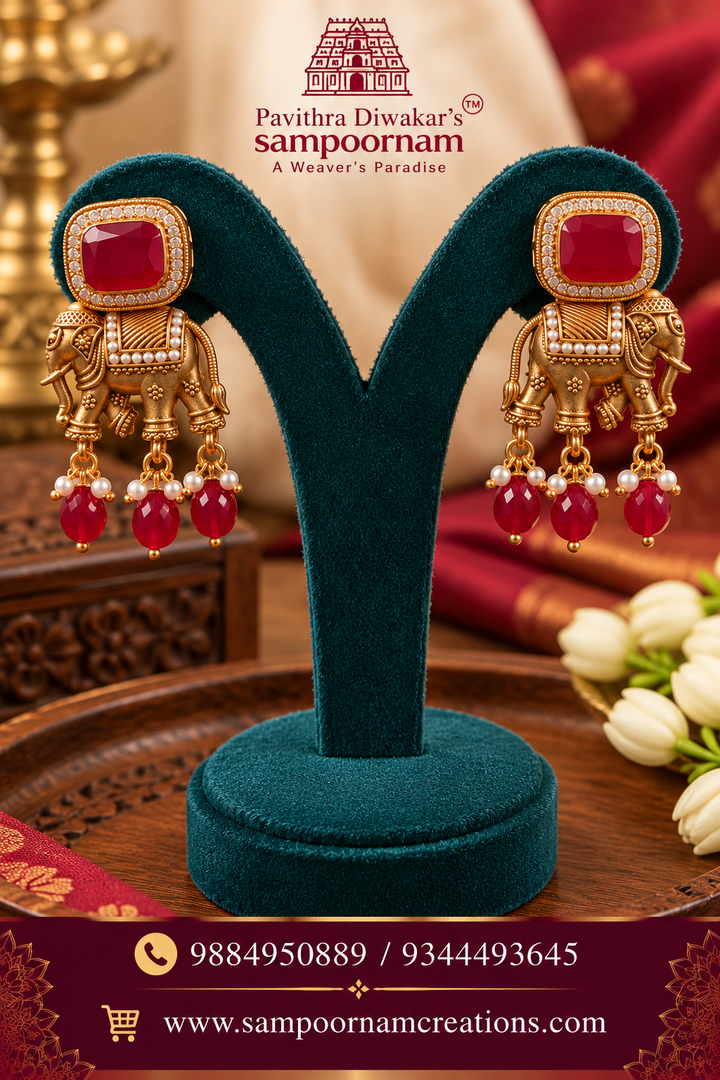 Royal elephant motif earrings adorned with rich ruby-red stones and delicate pearl drops.