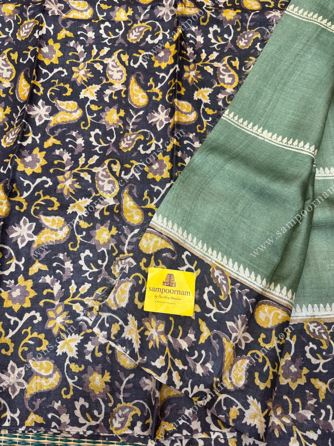 Green with Black , Handblock  Print in the body  with heavy  Paisley designs in the borders and Pallu  ,  Pure Tussar Silk Saree