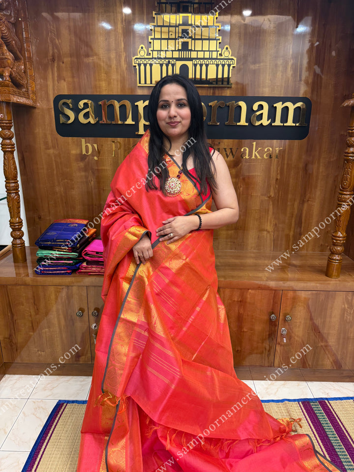 Peachish Pink , Green Selvedge , Vairaoosi Zari Lines in the body , traditional borders and rich Pallu ,Ten Yards Silk Cotton Saree