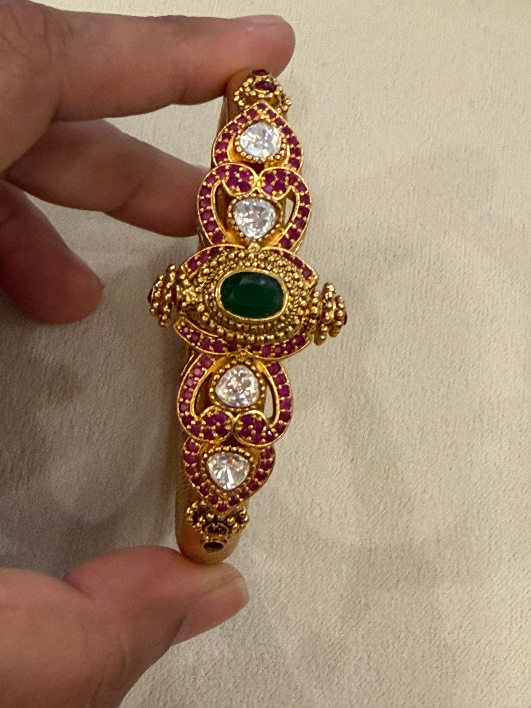Traditional Kangan Kada with a screw-type closure, beautifully studded with red, green & white stones. One standard size that fits 2/4, 2/6 & 2/8