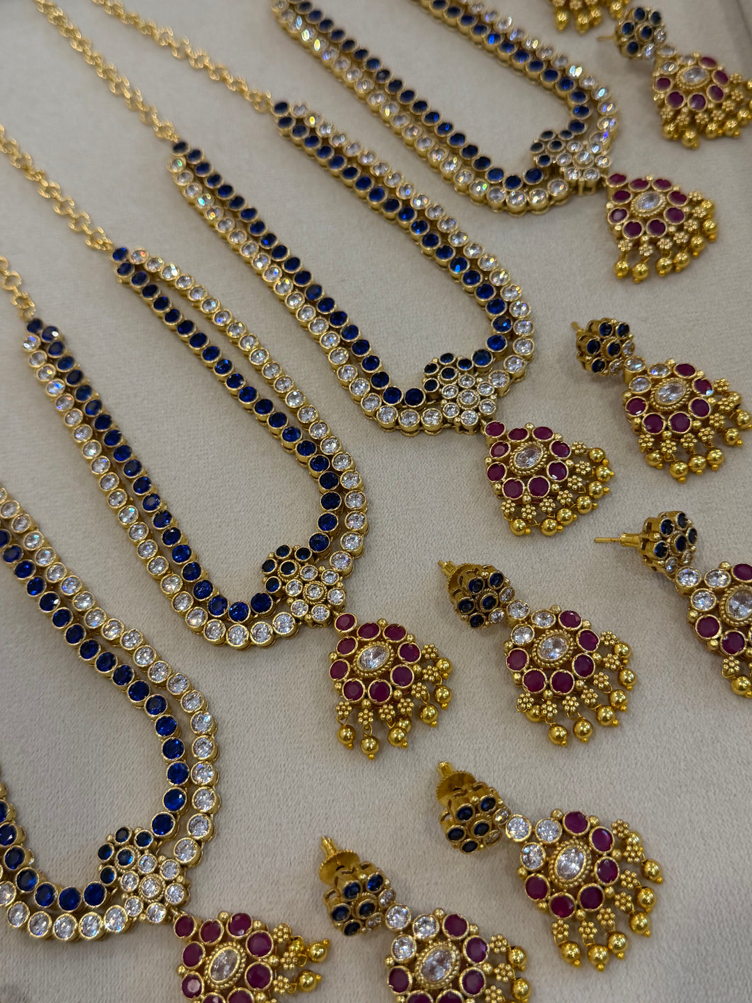 Two line elegant blue & white addigai necklaces, paired with a stunning red & white statement pendant and matching ear drops.
