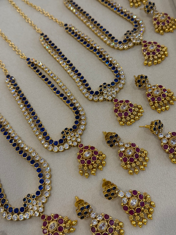 Two line elegant blue & white addigai necklaces, paired with a stunning red & white statement pendant and matching ear drops.