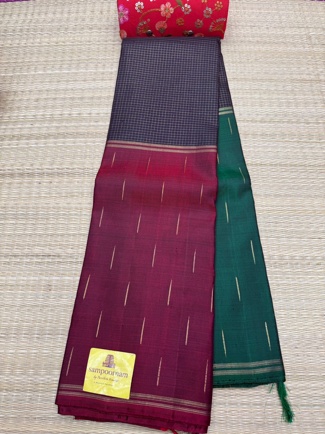 A classic mubagam in vibrant Black,maroon,green shade. Rich Zari Checks and Rain Drop Butta in the Borders and rich traditional pallu, pure silk pure zari Kanjivaram Silk Saree