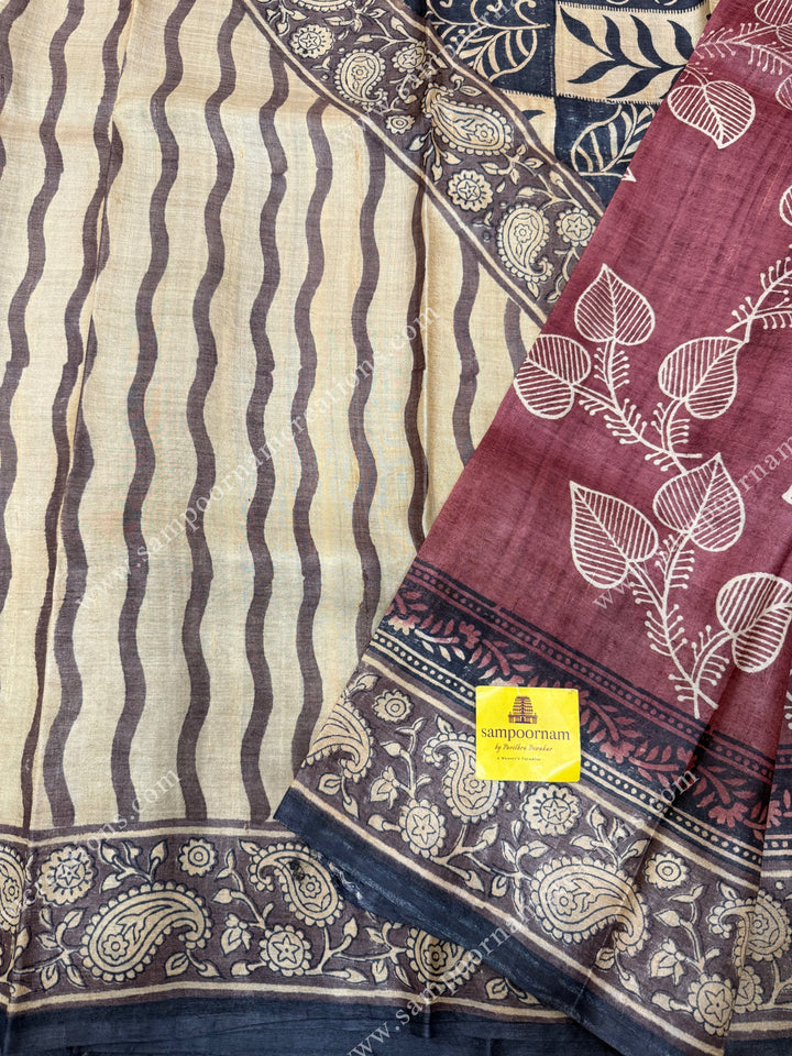 Maroon with Cream saree with Hand Painted leaf designs in the body and Paisley Prints in the border and Pallu ,  Pure Tussar Silk Saree