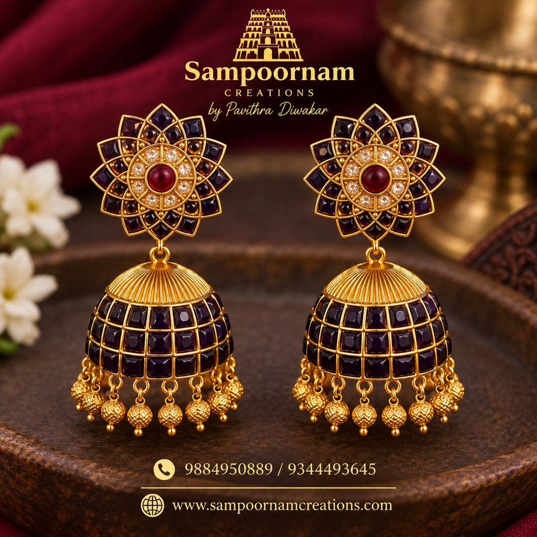 A Striking Floral - inspired Jhumka featuring Rich Blue Stones , accented with Sparkling White and Red Stones and intricate Gold - toned detailing . Finished with beautiful Gold Ball Hangings