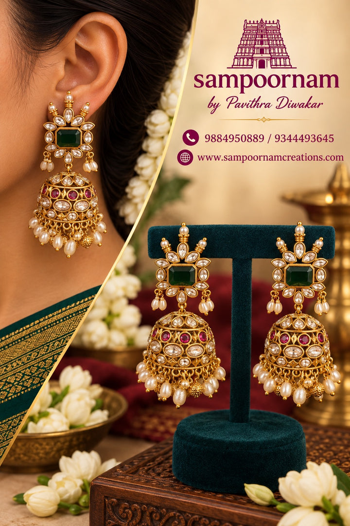 A Stunning Kemp style Jhumka featuring a Rich Emerald - Green centre stone , surrounded by Sparkling White Stones and Delicate Pearl accents