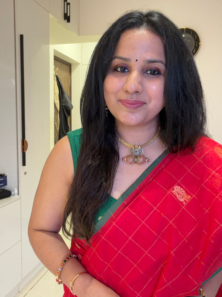 A beautiful red with green Selvedge, Zari Mayil butta and grand Kanchi pallu , Chettinad cotton saree