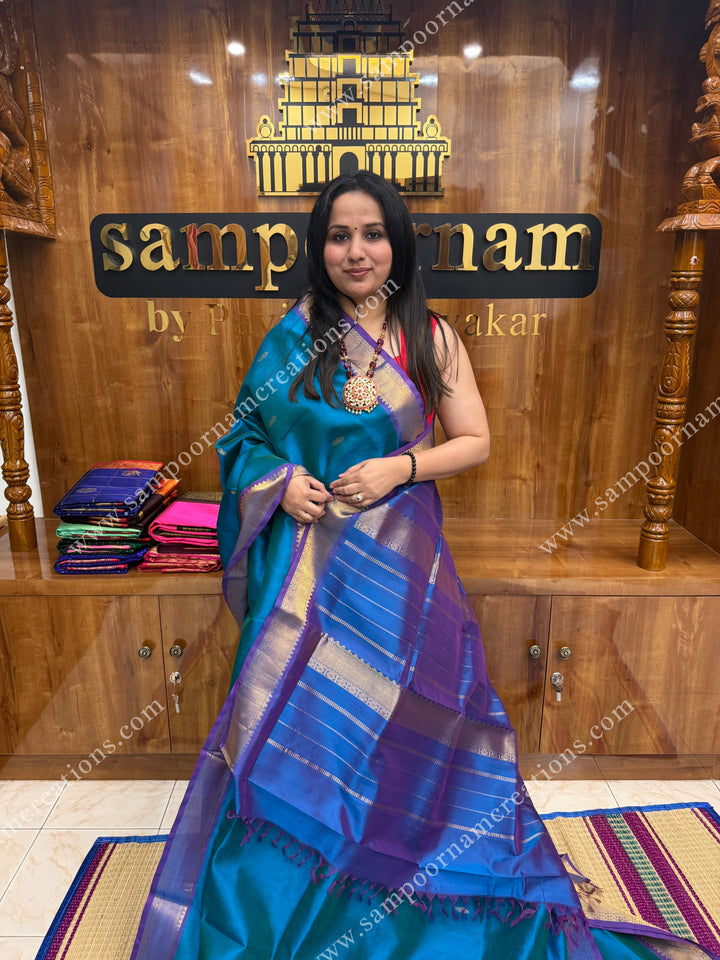 Blue with Mayilkazhuthu Blue  , Zari butta in the body ,   traditional borders and grand Pallu , Ten Yards Silk Cotton Saree