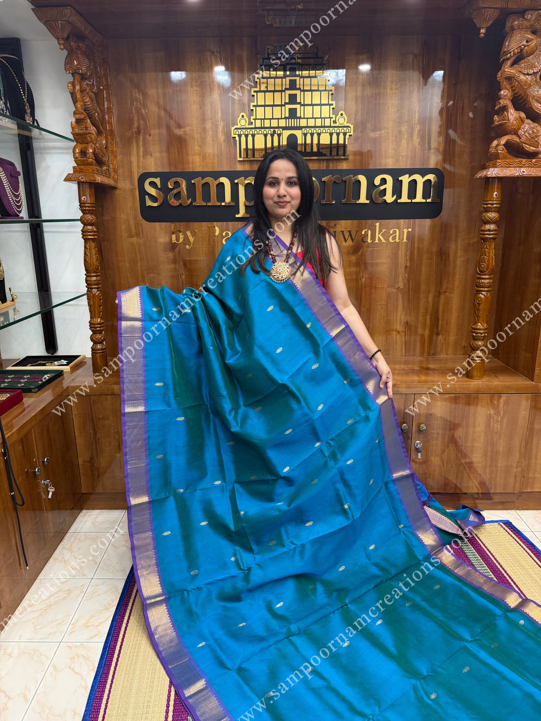 Blue with Mayilkazhuthu Blue  , Zari butta in the body ,   traditional borders and grand Pallu , Ten Yards Silk Cotton Saree