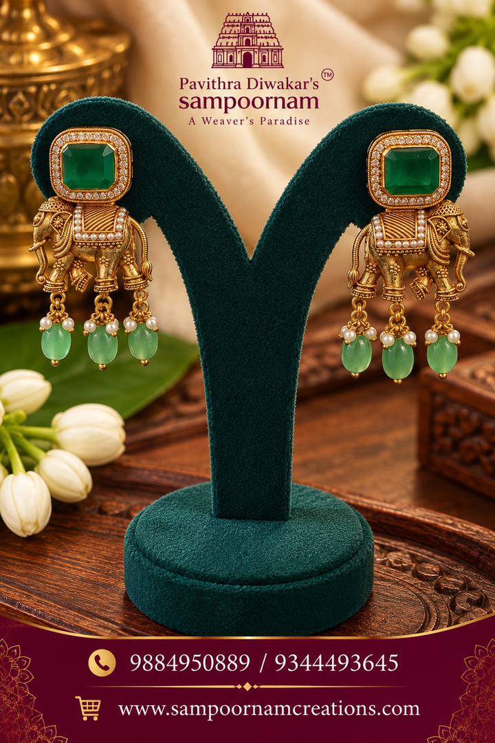 Elegant elephant motif earrings featuring rich emerald-green stones and delicate pearl drops.