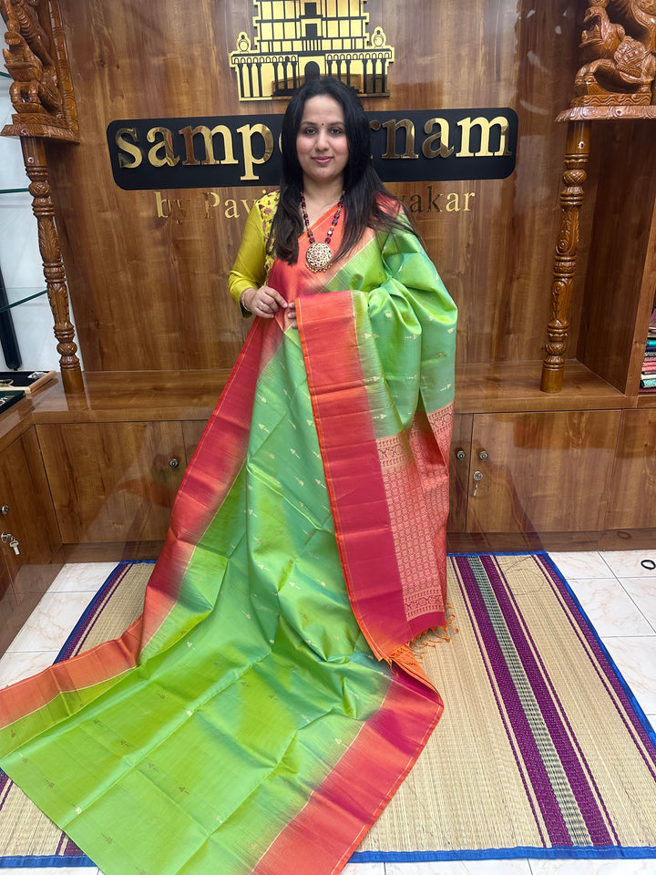 Double Shaded Green with Orangish Pink , Rich Zari Butta in the body and grand Pallu , Pure Soft Silk Saree