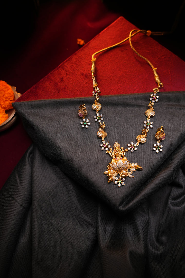 Divine Elegance , A traditional Necklace with a Mahalakshmi Pendant in red green and white stones with peacock detailing