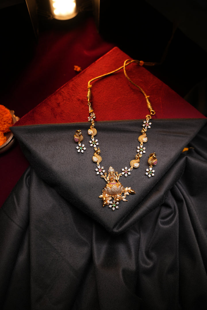 Divine Elegance , A traditional Necklace with a Mahalakshmi Pendant in red green and white stones with peacock detailing