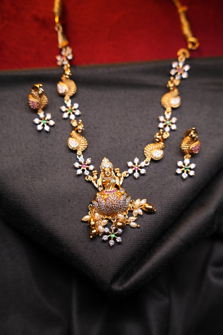 Divine Elegance , A traditional Necklace with a Mahalakshmi Pendant in red green and white stones with peacock detailing