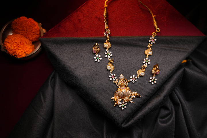 Divine Elegance , A traditional Necklace with a Mahalakshmi Pendant in red green and white stones with peacock detailing