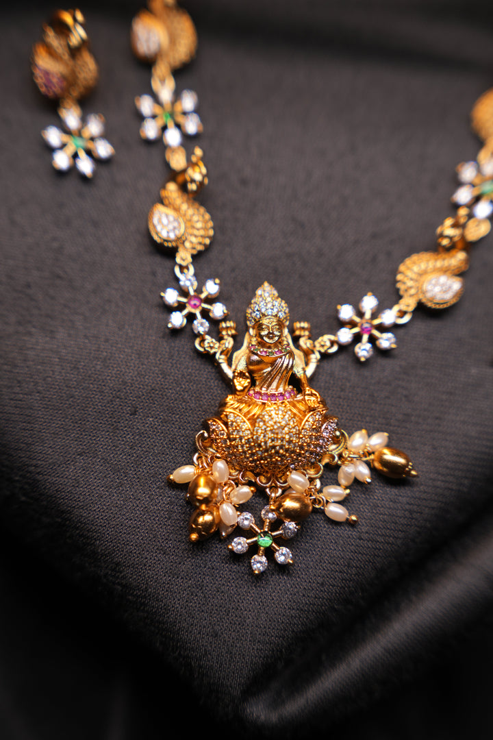 Divine Elegance , A traditional Necklace with a Mahalakshmi Pendant in red green and white stones with peacock detailing