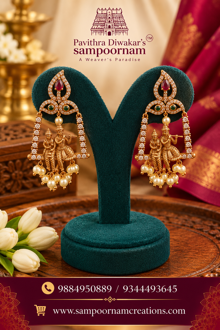 Elegant Krishna-Radha motif jhumkas with intricate gold detailing and sparkling stones.
Finished with delicate pearl drops for a timeless traditional look.
