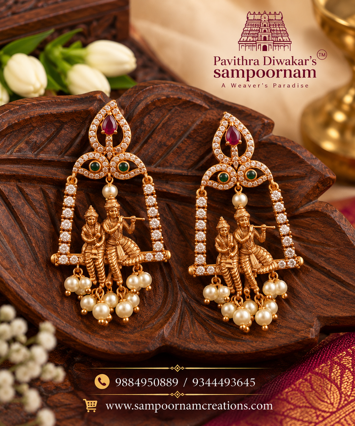 Elegant Krishna-Radha motif jhumkas with intricate gold detailing and sparkling stones.
Finished with delicate pearl drops for a timeless traditional look.