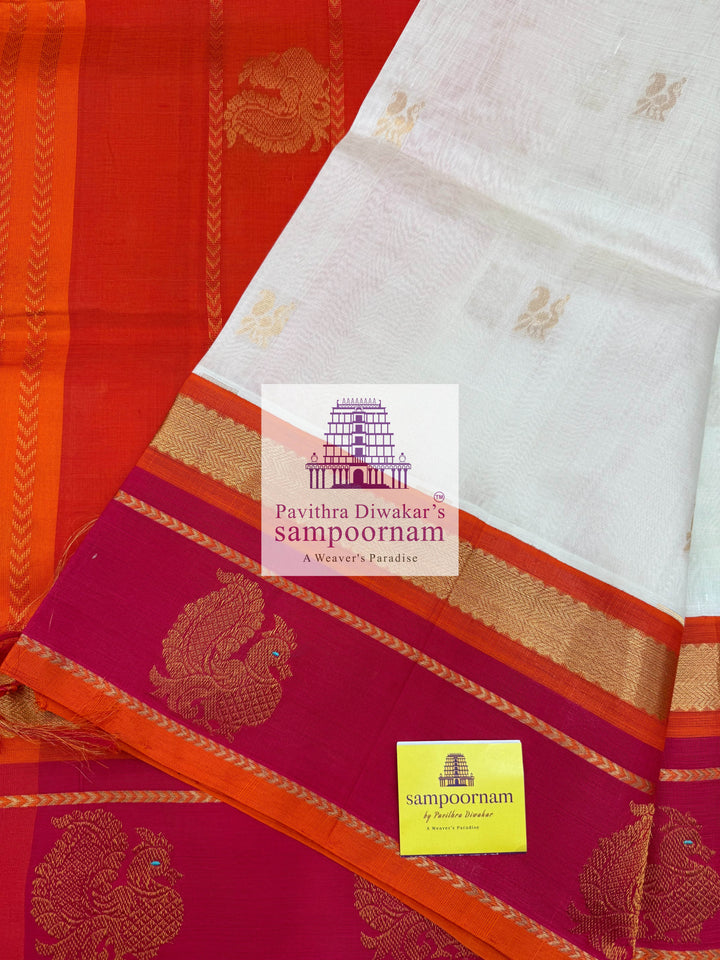 Offwhite with Orange, Rich Zari Butta in the Body, Traditional Borders with Peacock Motifs and Grand Pallu Korvai Silk Cotton Saree