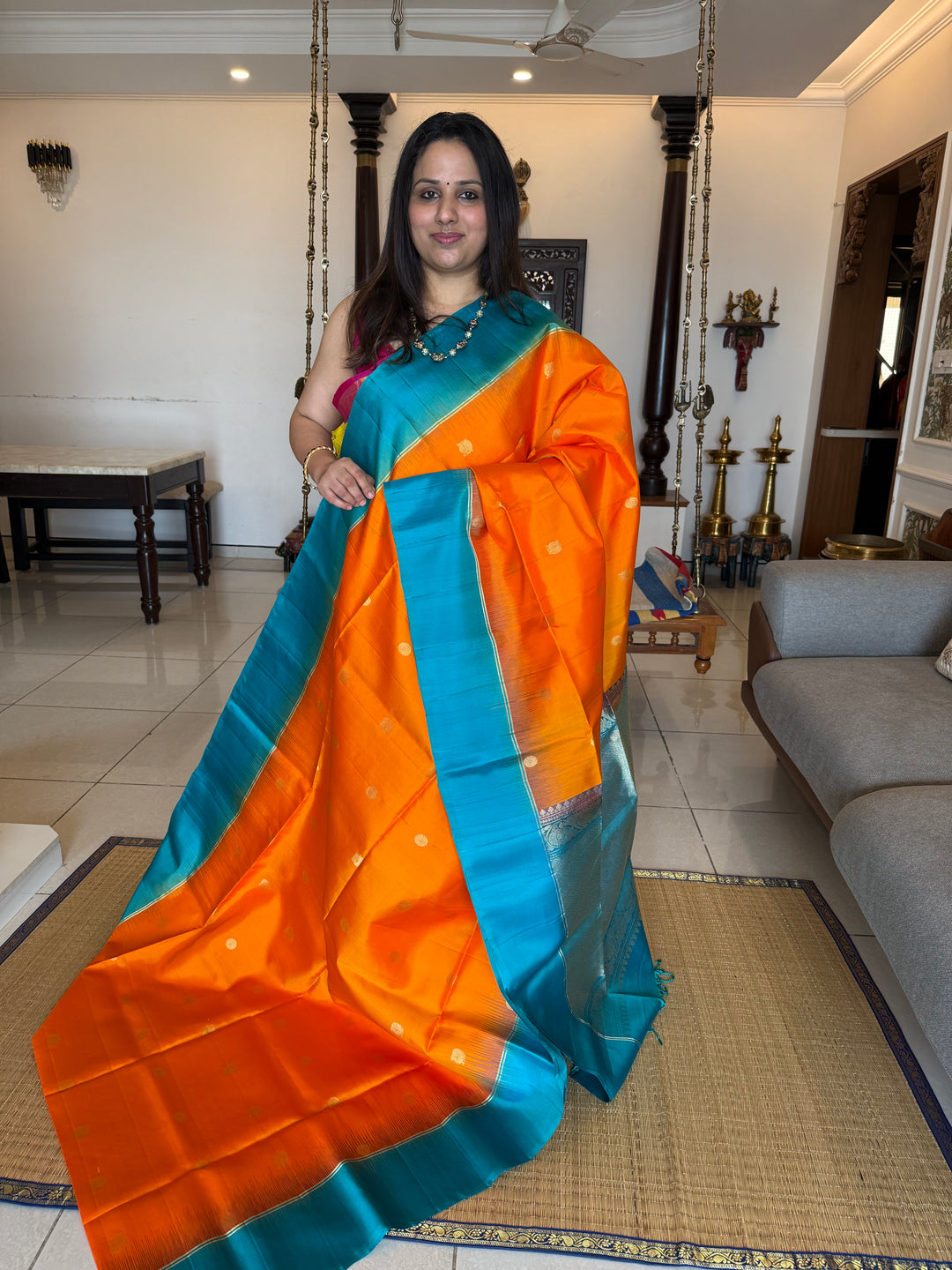 Fanta Orange with Turquoise Blue, rich zari butta in the body and an elaborate rich Pallu Pure Soft Silk Saree
