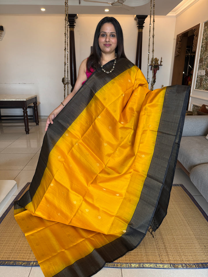 Manjal With Black vairasoosi lines in the border, rich  zari butta in the body and grand traditional Pallu Pure Soft Silk Saree