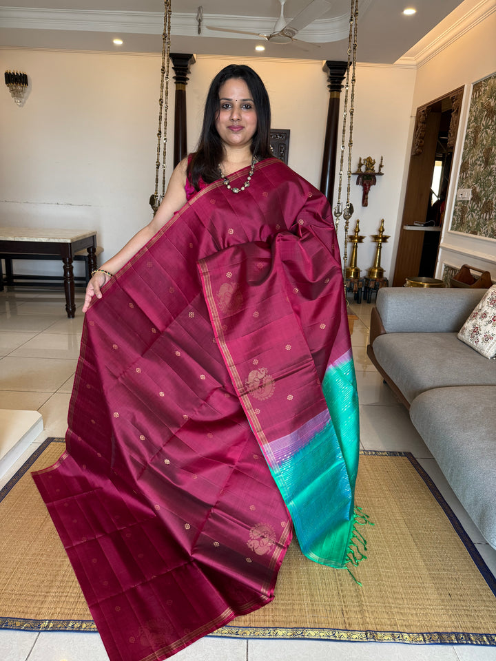 Deep Maroon With Turquoise Blue , rich annam butta in the lower border and small zari buttas in the body, rich Pallu Pure Soft Silk Saree