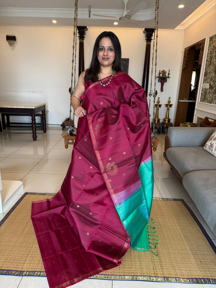 Deep Maroon With Turquoise Blue , rich annam butta in the lower border and small zari buttas in the body, rich Pallu Pure Soft Silk Saree