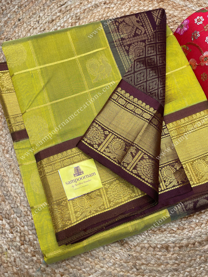 Lemon Green with Brown , rich Zari checks in the body , Mayil and Chakram rich butta in the body , traditional border and rich Pallu Silk Cotton Saree