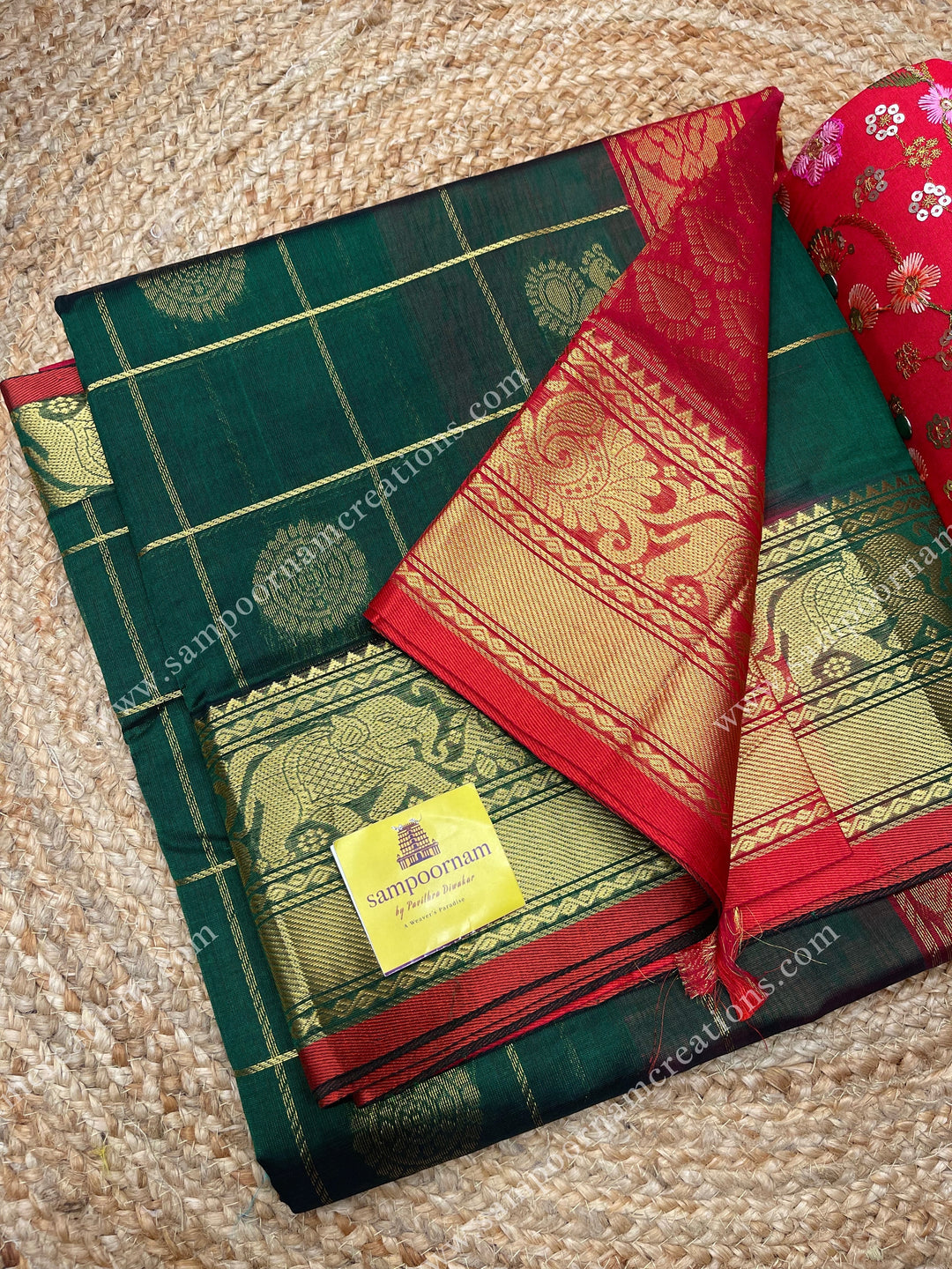 Green with Red , rich Zari checks in with Mayil and Chakram rich butta in the body , one side long traditional border and rich Pallu Silk Cotton Saree