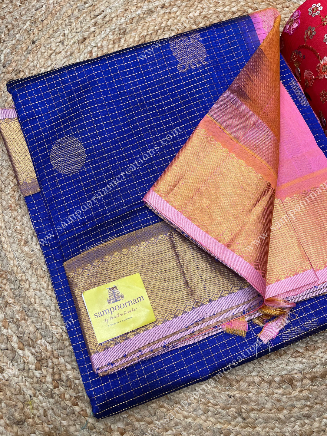 Blue with Baby Pink  , rich Zari checks and Mayil Chakram rich butta in the body , traditional border and  rich Pallu Silk Cotton Saree