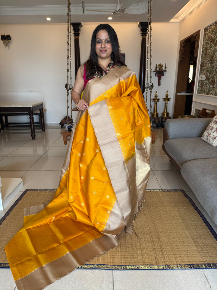 Musturd with Beige  , rich Annam and chakram  zari butta in the body and an elaborate rich Pallu Pure Soft Silk Saree