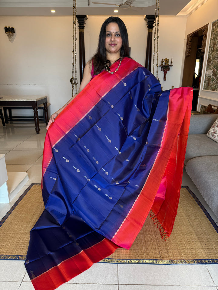 Dark Blue with Reddish Pink , rich silver and gold zari butta in the body and an elaborate rich Pallu Pure Soft Silk Saree