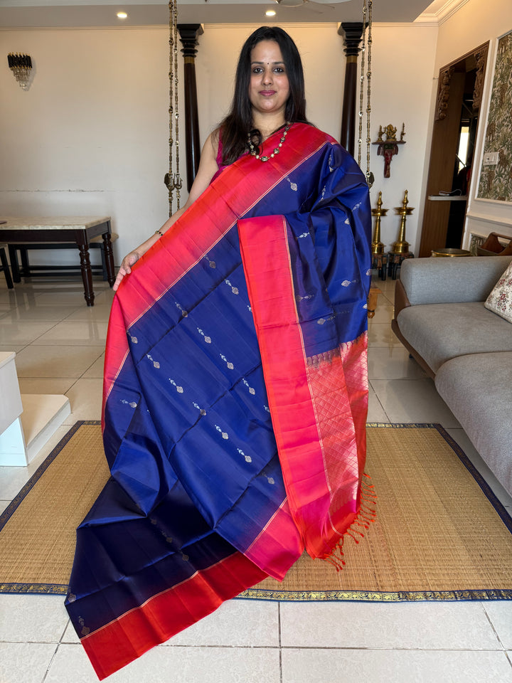 Dark Blue with Reddish Pink , rich silver and gold zari butta in the body and an elaborate rich Pallu Pure Soft Silk Saree