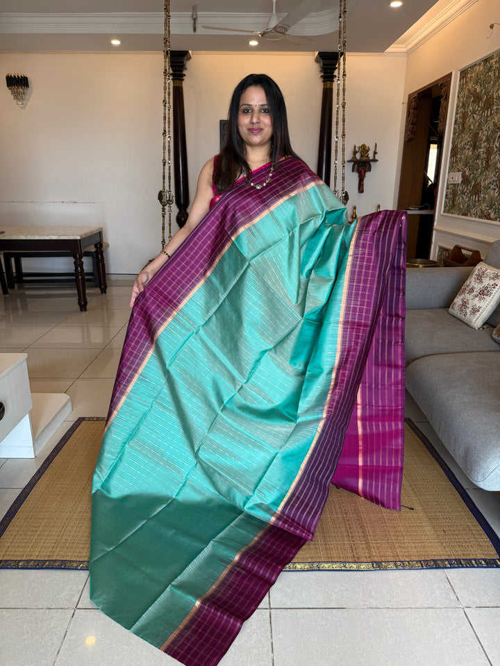 Light Rama Blue with Purple , rich zari vertical line all over the body , traditional checks border and grand Pallu Pure Soft Silk Saree