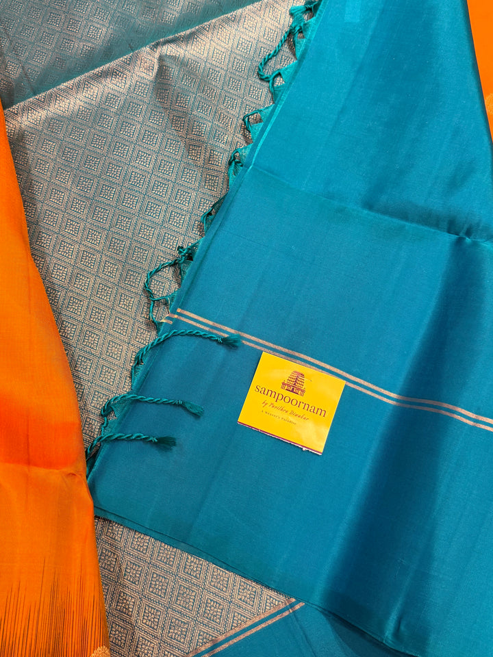 Fanta Orange with Turquoise Blue, rich zari butta in the body and an elaborate rich Pallu Pure Soft Silk Saree