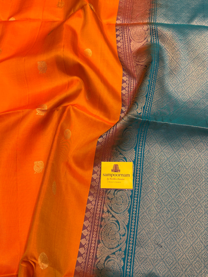 Fanta Orange with Turquoise Blue, rich zari butta in the body and an elaborate rich Pallu Pure Soft Silk Saree