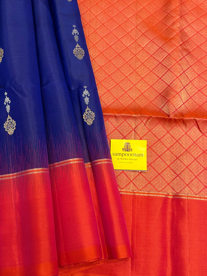 Dark Blue with Reddish Pink , rich silver and gold zari butta in the body and an elaborate rich Pallu Pure Soft Silk Saree