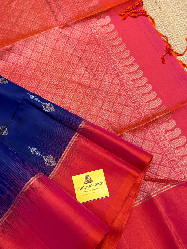 Dark Blue with Reddish Pink , rich silver and gold zari butta in the body and an elaborate rich Pallu Pure Soft Silk Saree