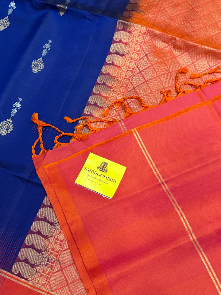 Dark Blue with Reddish Pink , rich silver and gold zari butta in the body and an elaborate rich Pallu Pure Soft Silk Saree