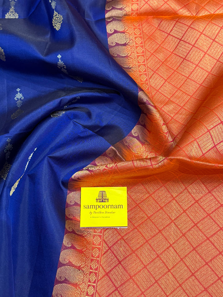 Dark Blue with Reddish Pink , rich silver and gold zari butta in the body and an elaborate rich Pallu Pure Soft Silk Saree