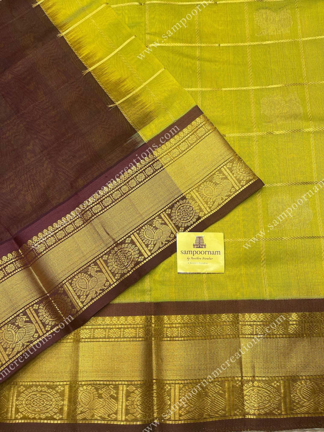 Lemon Green with Brown , rich Zari checks in the body , Mayil and Chakram rich butta in the body , traditional border and rich Pallu Silk Cotton Saree