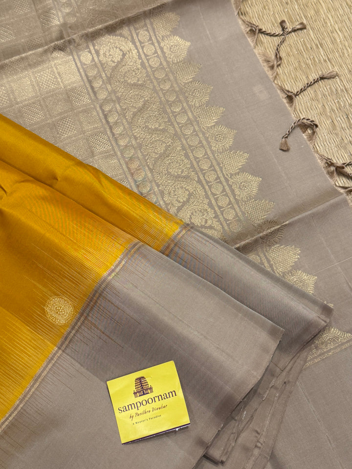 Musturd with Beige  , rich Annam and chakram  zari butta in the body and an elaborate rich Pallu Pure Soft Silk Saree