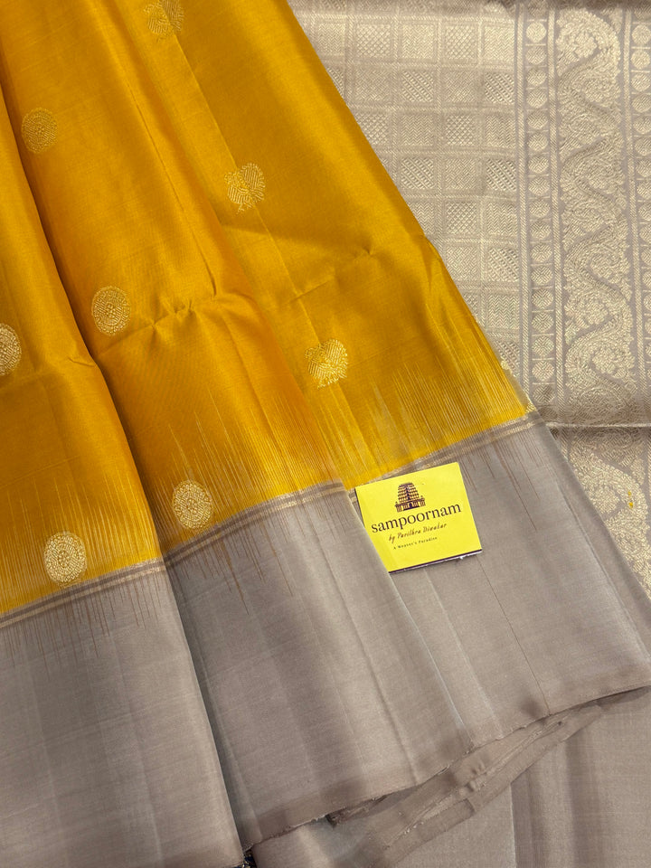 Musturd with Beige  , rich Annam and chakram  zari butta in the body and an elaborate rich Pallu Pure Soft Silk Saree