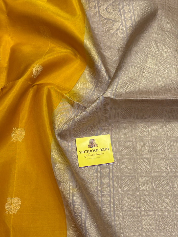 Musturd with Beige  , rich Annam and chakram  zari butta in the body and an elaborate rich Pallu Pure Soft Silk Saree