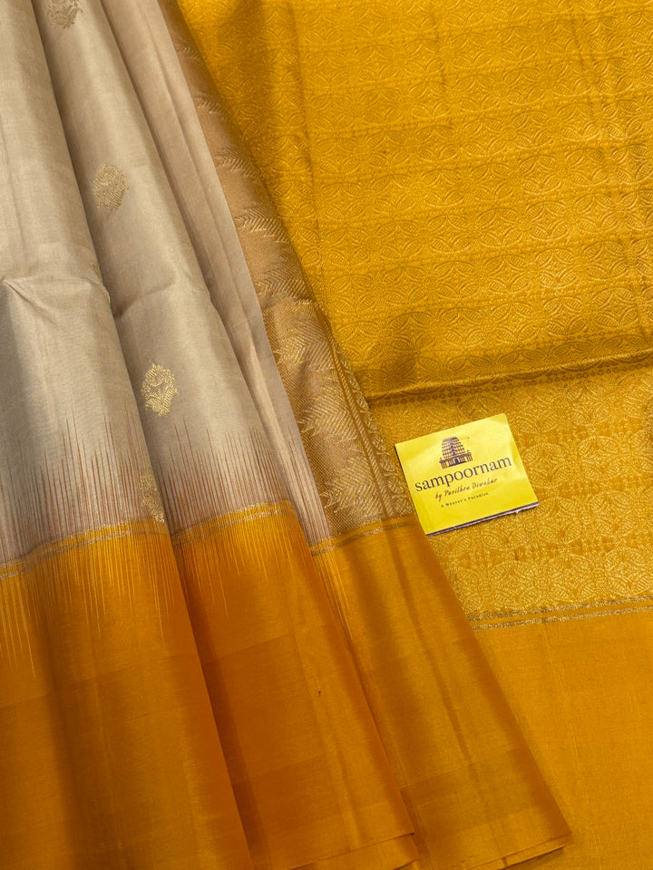 Offwhite with Mustard ,rich zari butta in the body and an elaborate rich Pallu Pure Soft Silk Saree